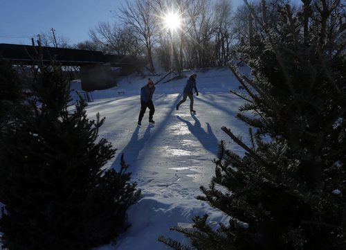 Stdup- LtoR Stu Taylor  and Chris Nicoletti  (Chris) who is visiting from Colorado are heading off for a skate on the extended river tail  Friady .Stdup  or Ashley  Prest brief -  The Forks is opening the second leg of the  river skating trail  this weekend . JAN. 17 2014 / KEN GIGLIOTTI / WINNIPEG FREE PRESS