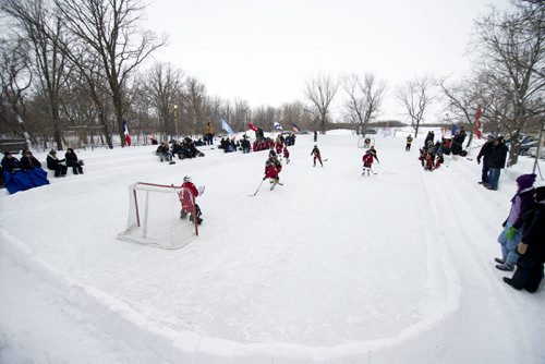140118 Winnipeg - DAVID LIPNOWSKI / WINNIPEG FREE PRESS (January 18, 2014)  Bill Martens, 69, of McCreary Road in Charleswood has made a huge backyard hockey rink with seating for 1,000. He calls it the Charity Rink & Snow Bowl, and he is hosting games to fundraise for four charities. On Saturday the South Winnipeg Kings battled the Fort Garry Flyers.