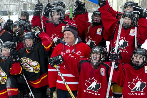 140118 Winnipeg - DAVID LIPNOWSKI / WINNIPEG FREE PRESS (January 18, 2014)  Bill Martens, 69, smiles during a group photo. Martins of McCreary Road in Charleswood has made a huge backyard hockey rink with seating for 1,000. He calls it the Charity Rink & Snow Bowl, and he is hosting games to fundraise for four charities. On Saturday the South Winnipeg Kings battled the Fort Garry Flyers.