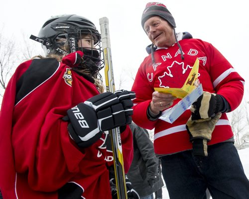 140118 Winnipeg - DAVID LIPNOWSKI / WINNIPEG FREE PRESS (January 18, 2014)  Maggie Mitani (age 9) gives Bill Martens (age 69) a thank you card Saturday afternoon after her game. Martens, of McCreary Road in Charleswood has made a huge backyard hockey rink with seating for 1,000. He calls it the Charity Rink & Snow Bowl, and he is hosting games to fundraise for four charities. On Saturday the South Winnipeg Kings battled the Fort Garry Flyers.