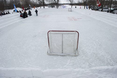 140118 Winnipeg - DAVID LIPNOWSKI / WINNIPEG FREE PRESS (January 18, 2014)  Bill Martens, 69, of McCreary Road in Charleswood has made a huge backyard hockey rink with seating for 1,000. He calls it the Charity Rink & Snow Bowl, and he is hosting games to fundraise for four charities. On Saturday the South Winnipeg Kings battled the Fort Garry Flyers.