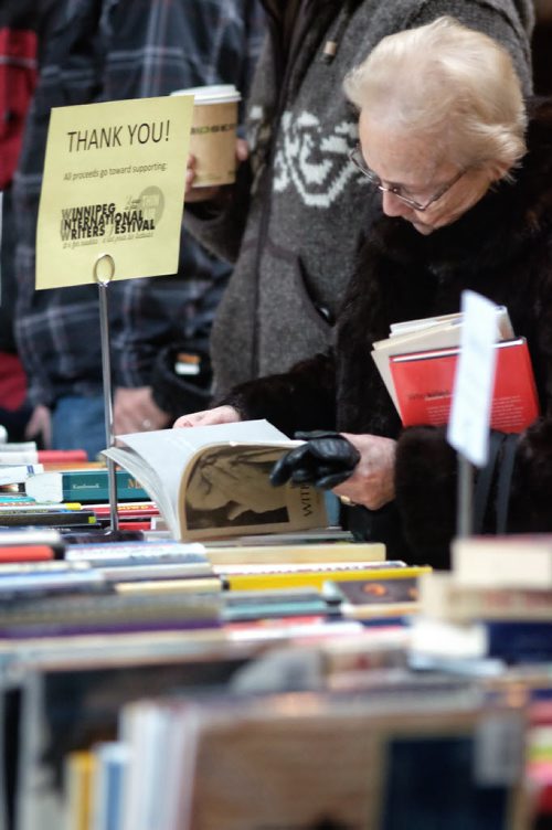 A visitor to The Forks browses through the book sale being held by the Winnipeg International Writers Festival. 140119 - January 19, 2014 MIKE DEAL / WINNIPEG FREE PRESS