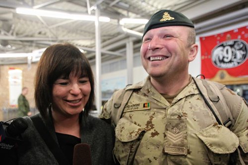 Sgt David Chelkowski with the 1st RCHA is greeted by his wife Jennifer after arriving in Winnipeg at 17 Wing from Afghanistan. About 11 soldiers landed in Winnipeg after serving several months on Canada's final commitment to Operation ATTENTION, Canada's contribution to the International Assistance Force / NATO Training Mission in Afghanistan. 140120 - January 20, 2014 MIKE DEAL / WINNIPEG FREE PRESS
