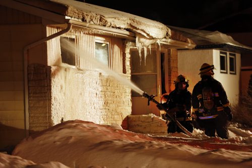 House fire on Horton Ave W.  Naer Hoka St in Transcona send two to hospital , fire fighters battle frigid temps change crews to stay warm and fight fire JAN. 21 2014 / KEN GIGLIOTTI / WINNIPEG FREE PRESS
