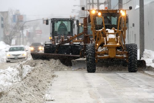 Massive snow clearing effort on Wall/Erin Sts today with heavy snow removal equipment  See weekend package- Jan 21, 2014   (JOE BRYKSA / WINNIPEG FREE PRESS)