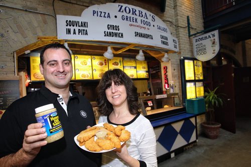 John Iliopoulos and his sister Patty at the Zorba's kiosk at The Forks. John Iliopoulos is the president of Greetalia Food Products, the only company in the world that markets honey dill sauce. The company's sauce is based on a recipe from Zorba's, the family-run biz at The Forks. Patty runs the operation at The Forks.   140121 - January 21, 2014 MIKE DEAL / WINNIPEG FREE PRESS