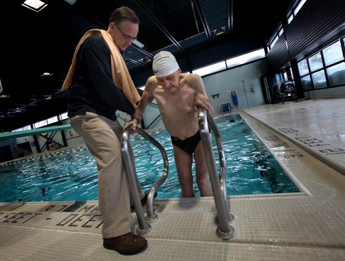 Jaring Timmerman, 105ys old,  is helped out of the pool after working his backstroke down the swimming lanes at Centennial Pool prepping for an upcoming swim competition. See story. January 21, 2014 - (Phil Hossack / Winnipeg Free Press)