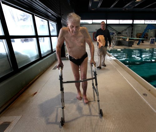 Followed by his son Don, Jaring Timmerman, 105ys old,  makes his way around the Centennial Pool's deck back to the change room after prepping for an upcoming swim competition. See story. January 21, 2014 - (Phil Hossack / Winnipeg Free Press)