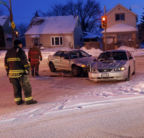STDUP -Drive safe roads are icy again-  Cold and Icy conditions have led to many minor MVC's inside the city and the Perimeter  during the morning rush hour  , this two car mvc  blocked Weston St. at Logan Ave , there were no serious injuries  , Hwy JAN. 22 2014 / KEN GIGLIOTTI / WINNIPEG FREE PRESS