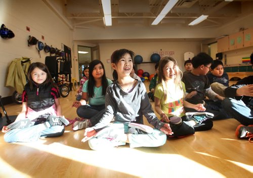 Grade three students from Greenway students do yoga during indoor recess because the cold temperatures do not allow them to have recess outside. Minh Nguyen (centre, green pants)  Ashley Prest story.  Jan 22,, 2014 Ruth Bonneville / Winnipeg Free Press
