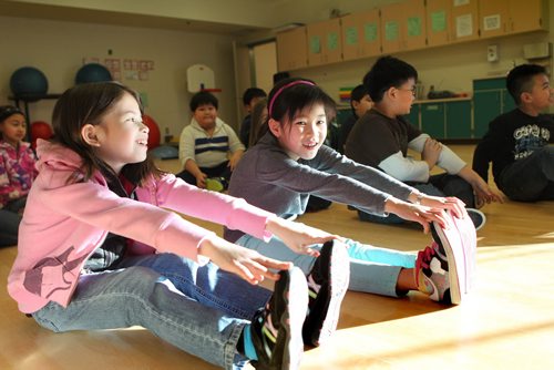 Grade three students from Greenway students do  yoga during indoor recess because the cold temperatures do not allow them to have recess outside. Mikaela Malubug (left ) and Minh Nguyen  green pants)  Ashley Prest story.  Jan 22,, 2014 Ruth Bonneville / Winnipeg Free Press