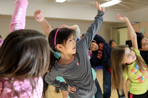 Grade three students from Greenway students do yoga during indoor recess because the cold temperatures do not allow them to have recess outside. Minh Nguyen (centre, green pants)  Ashley Prest story.  Jan 22,, 2014 Ruth Bonneville / Winnipeg Free Press