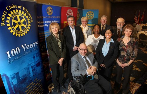 Rotary Club of Winnipeg members  pose for a photo after meeting at the Convention Centre. Philanthropy page. Names  from left -  Lucy Vogrig, Jason Kolaski,  Elly Hoogterp - Hurst, Don Ross (president, Glasses), Frank Cosway (red tie), Sandra Visentin (red hair), Rany Jeyaratnam' (blue), Tsungai Muvingi (white)  and Peter Tonge (wheelchair).  Jan 22,, 2014 Ruth Bonneville / Winnipeg Free Press