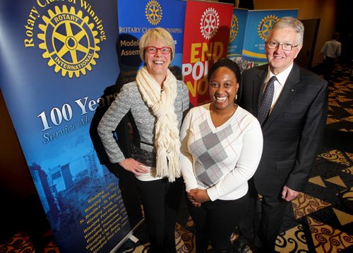 Rotary Club of Winnipeg members  pose for a photo after meeting at the Convention Centre. Philanthropy page. Names  from left -   Elly Hoogterp - Hurst, Don Ross (president, Glasses) and  Tsungai Muvingi (white).  Jan 22,, 2014 Ruth Bonneville / Winnipeg Free Press