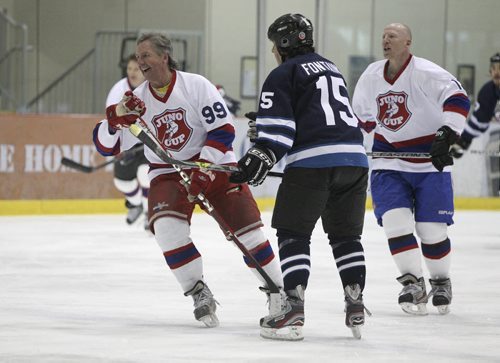 (l-r) Former NHL great Perry Miller (99), Eagle and Hawk's Vince Fontaine (15) and NHL great Mike Keane (12) during a scrimage at the MTS Iceplex Thursday morning. Former NHL greats and some Canadian music legends took to the ice at the MTS Iceplex for the Juno Cup Training Camp Thursday morning. The Juno Cup is a celebrity charity hockey game that takes place prior to the Juno Awards and pits former NHL stars and some of Canada's fearless musicians. 140123 - Thursday, January 23, 2014 -  (MIKE DEAL / WINNIPEG FREE PRESS)