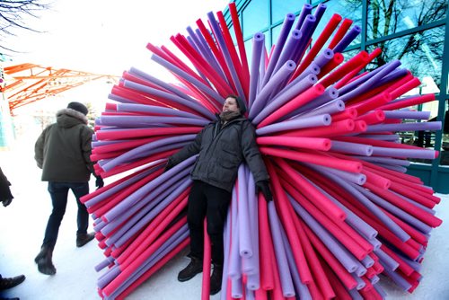 Asron Hendershott of  Raw Design  Inc- designers cozies up in one of their 3 unique and colourful warming huts that will be available for the public to try out along the River Trail soon during the annual The Warming Huts Architecture Competition on Ice at the Forks.  Names of Creators -  Pierre-Alexandre Le Lay, Asron Hendershott and Jacob Shank.    Jan 22,, 2014 Ruth Bonneville / Winnipeg Free Press