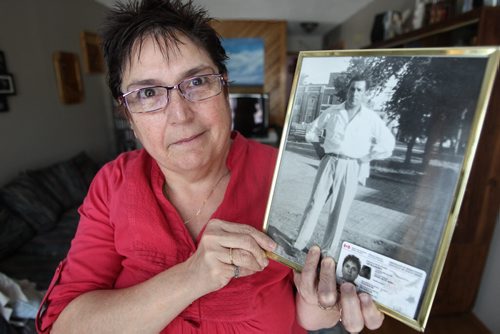 Debbie Scott is one of 2,600 people in Manitoba who got their Indian Status back after Ottawa reformed legislation that discriminated against aboriginal women who married white men. She is holding a photo of her father who lost his status because his mother, Debbie's grandmother, was white and married an aboriginal man. In the bottom of the portrait of her father is Debbie's Indian Status card. 140123 - Thursday, January 23, 2014 -  (MIKE DEAL / WINNIPEG FREE PRESS)