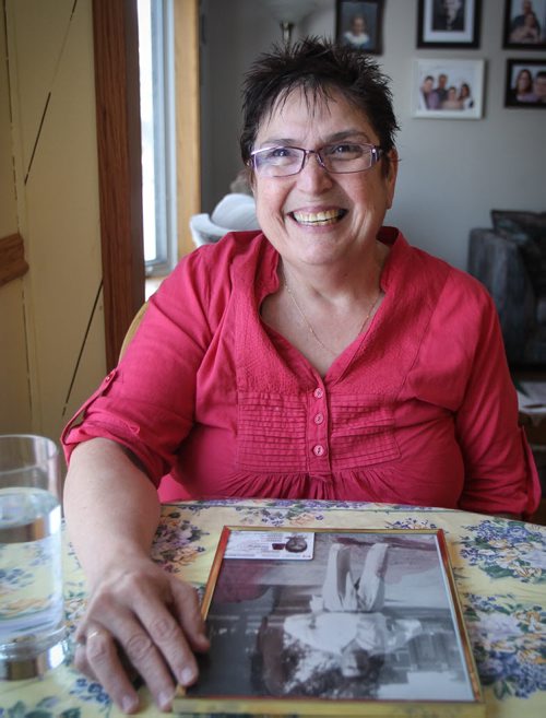 Debbie Scott is one of 2,600 people in Manitoba who got their Indian Status back after Ottawa reformed legislation that discriminated against aboriginal women who married white men. On the table is a photo of her father who lost his status because his mother, Debbie's grandmother, was white and married an aboriginal man. In the bottom of the portrait of her father is Debbie's Indian Status card. 140123 - Thursday, January 23, 2014 -  (MIKE DEAL / WINNIPEG FREE PRESS)