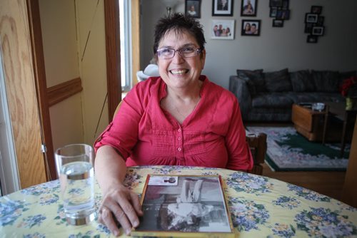 Debbie Scott is one of 2,600 people in Manitoba who got their Indian Status back after Ottawa reformed legislation that discriminated against aboriginal women who married white men. On the table is a photo of her father who lost his status because his mother, Debbie's grandmother, was white and married an aboriginal man. In the bottom of the portrait of her father is Debbie's Indian Status card. 140123 - Thursday, January 23, 2014 -  (MIKE DEAL / WINNIPEG FREE PRESS)