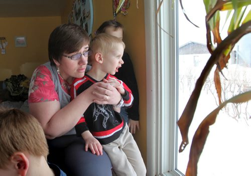 Eveline Wiebe looks out her living room window with her son Larry-2yrs,  where she could see flames in the middle of the night after natural gas explosion near their home in Otterburne.   Jan 25,, 2014 Ruth Bonneville / Winnipeg Free Press