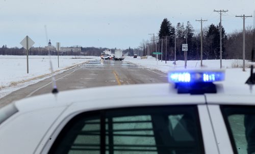 Ann RCMP Officer stands at a road block at the corner of Hwy #59 and Road 303 heading into Otterburne Saturday after a natural gas pipeline exploded earlier in the morning forcing evacuation of homes in the area. See Geoff Kirbyson's story.  Jan 25,, 2014 Ruth Bonneville / Winnipeg Free Press