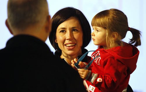 Jill Officer and her 2 year old daughter, Camryn, speaking with a visitor during her sendoff at the Manitoba Sports Hall of Fame, January 25, 2014. (TREVOR HAGAN/WINNIPEG FREE PRESS)