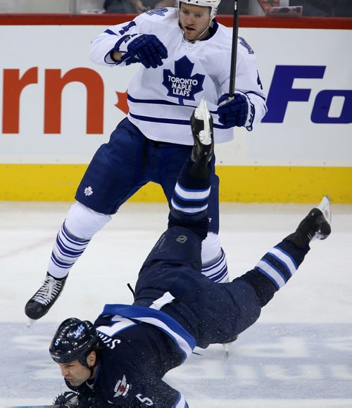 Toronto Maple Leafs' Cody Franson (4) collides with Winnipeg Jets' Mark Stuart (5) during first period NHL hockey action at MTS Centre in Winnipeg, Saturday, January 25, 2014. (TREVOR HAGAN/WINNIPEG FREE PRESS)