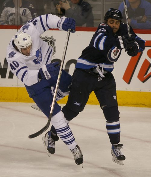Jets' forward Dustin Byfuglien knocks down Leafs' forward Troy Bodie in the second period at MTS Centre Saturday night.  140125 - Saturday, {month name} 25, 2014 - (Melissa Tait / Winnipeg Free Press)