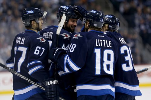 Winnipeg Jets' Michael Frolik (67), Andrew Ladd (16), not shown, Zach Bogosian (44), Bryan Little (18) and Tobias Enstrom (39) celebrate after Bogosian scored against the Toronto Maple Leafs' during second period NHL hockey action at MTS Centre in Winnipeg, Saturday, January 25, 2014. (TREVOR HAGAN/WINNIPEG FREE PRESS)
