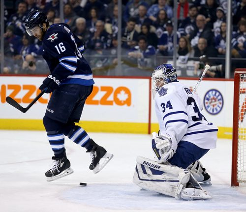 Winnipeg Jets' Andrew Ladd (16) jumps over a shot by Bryan Little (18), not shown, that gets past Toronto Maple Leafs' goaltender James Reimer (34) during second period NHL hockey action at MTS Centre in Winnipeg, Saturday, January 25, 2014. (TREVOR HAGAN/WINNIPEG FREE PRESS)