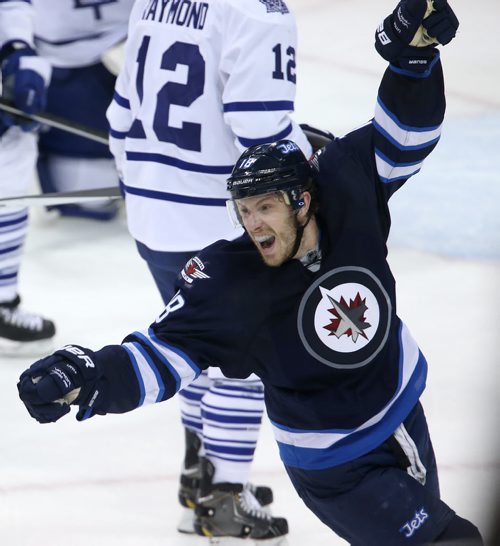 Winnipeg Jets' Bryan Little (18) celebrates after Dustin Byfuglien (33) scored to beat the Toronto Maple Leafs' during overtime NHL hockey action at MTS Centre in Winnipeg, Saturday, January 25, 2014. (TREVOR HAGAN/WINNIPEG FREE PRESS)