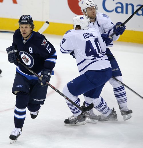 Winnipeg Jets' Olli Jokinen (12) side steps a check that leaves Toronto Maple Leafs' Troy Bodie (40) and Jay McClement (11) colliding with one another during third period NHL hockey action at MTS Centre in Winnipeg, Saturday, January 25, 2014. (TREVOR HAGAN/WINNIPEG FREE PRESS)