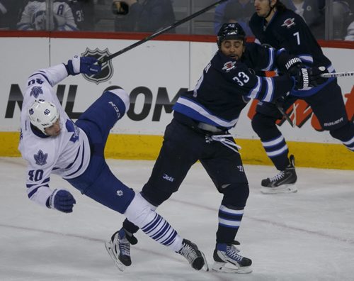 Jets' forward Dustin Byfuglien knocks down Leafs' forward Troy Bodie in the second period at MTS Centre Saturday night.  140125 - Saturday, {month name} 25, 2014 - (Melissa Tait / Winnipeg Free Press)