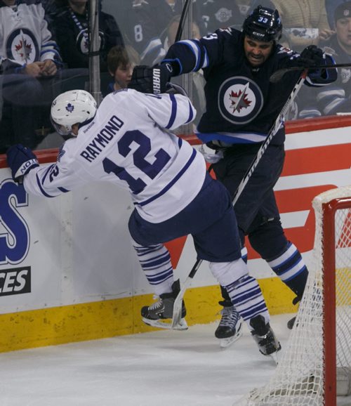 Jets' forward Dustin Byfuglien knocks down Leafs' forward Mason Raymond in the second period at MTS Centre Saturday night.  140125 - Saturday, {month name} 25, 2014 - (Melissa Tait / Winnipeg Free Press)