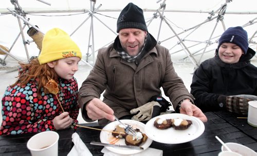 Kerry LeBlanc plates some breakfast latke's for his daughter Kwynn (left), 10, and son, Karter (right), 13, during the brunch service at the River Pop-up restaurant located on the Assiniboine River at The Forks.  140126 - January 26, 2014 MIKE DEAL / WINNIPEG FREE PRESS