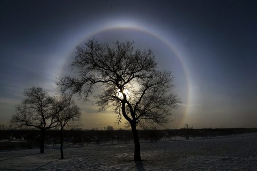 Halo- A Halo appears around the sun in Winnipeg Monday morning during extreme cold temperatures on the top of a hill in  Westview Park (Garbage Hill)- According to Wikipedia, a halo  is a optical phenomenon produced by ice crystals  creating white or coloured arches in the sky Standup photo- Jan 27, 2014   (JOE BRYKSA / WINNIPEG FREE PRESS). weather