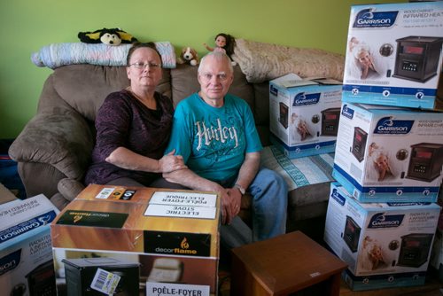 Otterburne residents Shirley Bernardin and her husband Jules in their living room surrounded by the boxes of space heaters they bought to keep their house and water pipes warm after they lost gas due to the TransCanada pipeline explosion near Otterburne. Shirley Bernardin  already had her heat and gas back already. See Rollason story. 140127 - Monday, {month name} 27, 2014 - (Melissa Tait / Winnipeg Free Press)