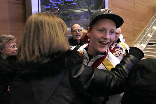 January 27, 2014 - 140127  - Canadian junior curling champion Braden Calvert is greeted by a supporter as the team arrives at the Winnipeg airport Monday, January 27, 2014. John Woods / Winnipeg Free Press