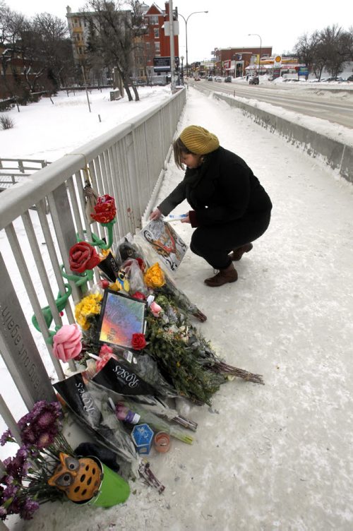 Rachelle Garton attaches a painting at the memorial on the Osborne Bridge she did in honour of her friend  and murder victim Joshua Bentley, 18, she has known Joshua since she was five years old. He was stabbed Friday night in an area not far from the Osborne Bridge. A 20-year-old man was also injured but survived, a male has been arrested.     Wayne Glowacki / Winnipeg Free Press Jan.28  2014