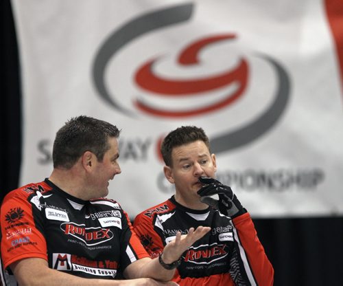 Draw 2 of the 2014 Safeway Championships at the MTS Iceplex in Winnipeg Wednesday morning  Skip Rob Fowler from Brandon , right, chats his third Allan Lyburn during play against Geoff Trimble from Gladstone- See Paul Wiecek story- Jan 29, 2014   (JOE BRYKSA / WINNIPEG FREE PRESS)