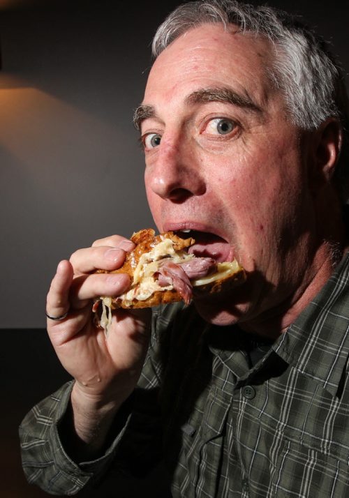Tim Turner, who with a group a of friends spent some time rating Reuben sandwiches around Winnipeg, takes a bite out of one at the Oakwood Cafe on Osborne Street. 140129 - Wednesday, January 29, 2014 -  (MIKE DEAL / WINNIPEG FREE PRESS)