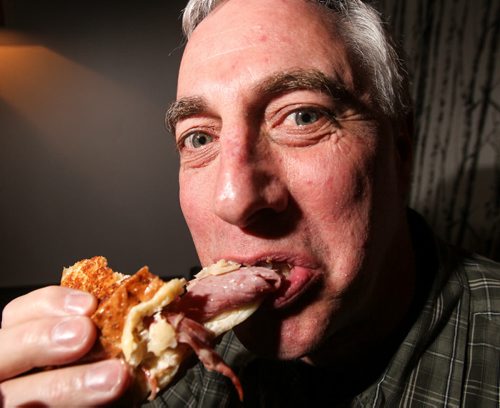 Tim Turner, who with a group a of friends spent some time rating Reuben sandwiches around Winnipeg, takes a bite out of one at the Oakwood Cafe on Osborne Street. 140129 - Wednesday, January 29, 2014 -  (MIKE DEAL / WINNIPEG FREE PRESS)