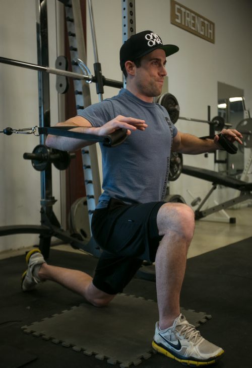 Tim Shantz demonstrates a chest press on one knee to engage lower body and core to fight gravity during the exercise. 140128 - Tuesday, {month name} 28, 2014 - (Melissa Tait / Winnipeg Free Press)