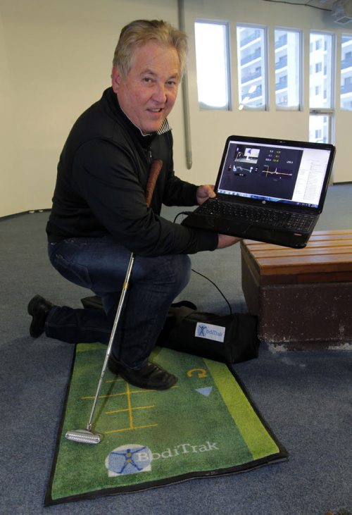 Terry Hashimoto has developed a sensored mat that gives you an electronic reading on a computer of your balance (whether your weight is on your right or left foot, if you're on your heels or toes) and can measure the speed of your arms when you swing a club. This new product can help sell golf clubs and shoes, which can match your needs, as well as teach how the weight should be distributed during putting for example. Once you have the right distribution, you get a feel for it, step off the mat and do it again without looking at the computer so you learn how you should set up. Here he poses with the product that is made in Winnipeg. BORIS MINKEVICH / WINNIPEG FREE PRESS. JAN 30, 2014