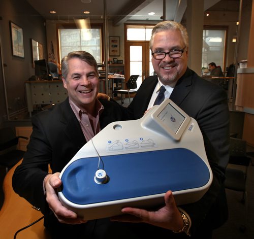 Brothers Christopher (left)CEO and Paul Moreau (VP Sales/Marketing) show off "Scout", a Miraculins  medical diagnostic technologies, non-invasive pre-diabetes screening instrument.Their firm Miraculins, just signed a deal with a Chinese distributor for this device, that could eventually be worth $100 million over the five year term of the agreement. See Martin Cash story. January 31, 2014 - (Phil Hossack / Winipeg Free Press)