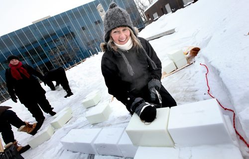 Winipeg Artist Erica Swendrowski lays snow blocks as she and Winnipeg Arts Council Members and volunteers got work started on a Snow Maze behind the downtown library Friday morning. WHERE: Millennium Library and Park (251 Donald Street) WHEN: Friday, January 31st (11:00 AM) WHAT: Preview of snow maze build VISUALS: Snow clearing, creating maze layout, block filling, block stacking  This snow maze build joins Winnipegs growing list of one-of-a-kind wintery outdoor activities. Billed as SnowMAZEing, the snow maze event invites Winnipeg citizens  young and old  to celebrate winter and art by creating a community snow maze at the Millennium Library and Park on February 1, 2014. People are encouraged to bring their shovel to enjoy the main event: joining in building a maze out of snow bricks, then warm up inside with hot chocolate, reading and crafts. After a frigid start to the winter, Winnipeggers are sure to embrace the opportunity to enjoy outdoor activities in true winter-city spirit!  Presented by the Winnipeg Arts Council, the Winnipeg Public Library Millennium Branch, and the Downtown Winnipeg BIZ, SnowMAZEing is a unique event that will give people a chance to enjoy some outside winter fun, while appreciating some of the citys beautiful public art. Inspired by the public art piece Sentinel of Truth which features quotes from literary works, the snow maze will also feature book inspired art panels. Over the winter holidays families were invited to create drawings inspired by their favourite childrens book or quote. This artwork will be on display in the Library and frozen into the walls of the maze. For more information, visit www.winnipegarts.ca. January 31, 2014 - (Phil Hossack / Winipeg Free Press)