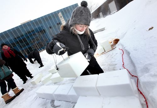 Winipeg Artist Erica Swendrowski lays snow blocks as she and Winnipeg Arts Council Members and volunteers got work started on a Snow Maze behind the downtown library Friday morning. WHERE: Millennium Library and Park (251 Donald Street) WHEN: Friday, January 31st (11:00 AM) WHAT: Preview of snow maze build VISUALS: Snow clearing, creating maze layout, block filling, block stacking  This snow maze build joins Winnipegs growing list of one-of-a-kind wintery outdoor activities. Billed as SnowMAZEing, the snow maze event invites Winnipeg citizens  young and old  to celebrate winter and art by creating a community snow maze at the Millennium Library and Park on February 1, 2014. People are encouraged to bring their shovel to enjoy the main event: joining in building a maze out of snow bricks, then warm up inside with hot chocolate, reading and crafts. After a frigid start to the winter, Winnipeggers are sure to embrace the opportunity to enjoy outdoor activities in true winter-city spirit!  Presented by the Winnipeg Arts Council, the Winnipeg Public Library Millennium Branch, and the Downtown Winnipeg BIZ, SnowMAZEing is a unique event that will give people a chance to enjoy some outside winter fun, while appreciating some of the citys beautiful public art. Inspired by the public art piece Sentinel of Truth which features quotes from literary works, the snow maze will also feature book inspired art panels. Over the winter holidays families were invited to create drawings inspired by their favourite childrens book or quote. This artwork will be on display in the Library and frozen into the walls of the maze. For more information, visit www.winnipegarts.ca. January 31, 2014 - (Phil Hossack / Winipeg Free Press)