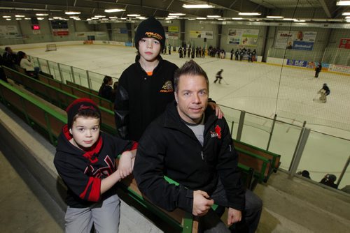 Jason Thor, president of St. Boniface Minor Hockey Association has two young boys in minor hockey. L-R kids Evan and Alex. Story on Winnipeg Hockey thinking about introducing mandatory Respect in Hockey program for parents. Totally in favour of program. BORIS MINKEVICH / WINNIPEG FREE PRESS. JAN 31, 2014