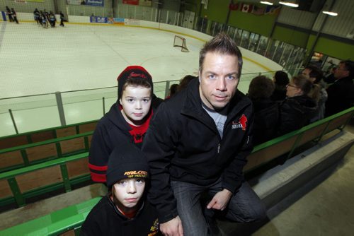 Jason Thor, president of St. Boniface Minor Hockey Association has two young boys in minor hockey. Kids Evan, back, and Alex, front. Story on Winnipeg Hockey thinking about introducing mandatory Respect in Hockey program for parents. Totally in favour of program. BORIS MINKEVICH / WINNIPEG FREE PRESS. JAN 31, 2014