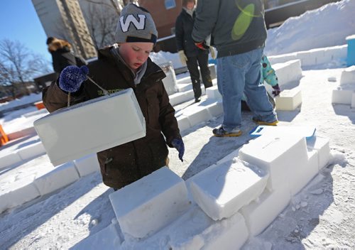 Lenny Wilson, 8, who recently moved here from Melbourne, Australia,, works on a snow block at the Snow Maze being assembled at the Millennium Library, Saturday, February 1, 2014. (TREVOR HAGAN/WINNIPEG FREE PRESS)